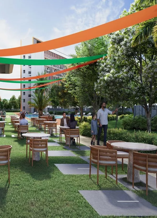 Outdoor cafe seating area with landscaped gardens at Satya Levante Residences